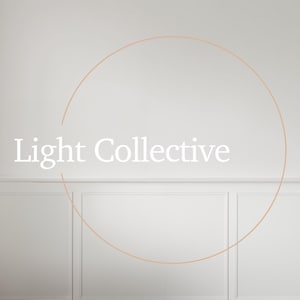 May include: A white wall with a light brown circle and the text "Light Collective" in the center.