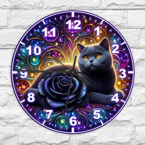 May include: Round wall clock featuring a gray cat with yellow eyes, a black rose, and a colorful, abstract background. The clock face has white numbers and black clock hands. The clock is mounted on a white brick wall.