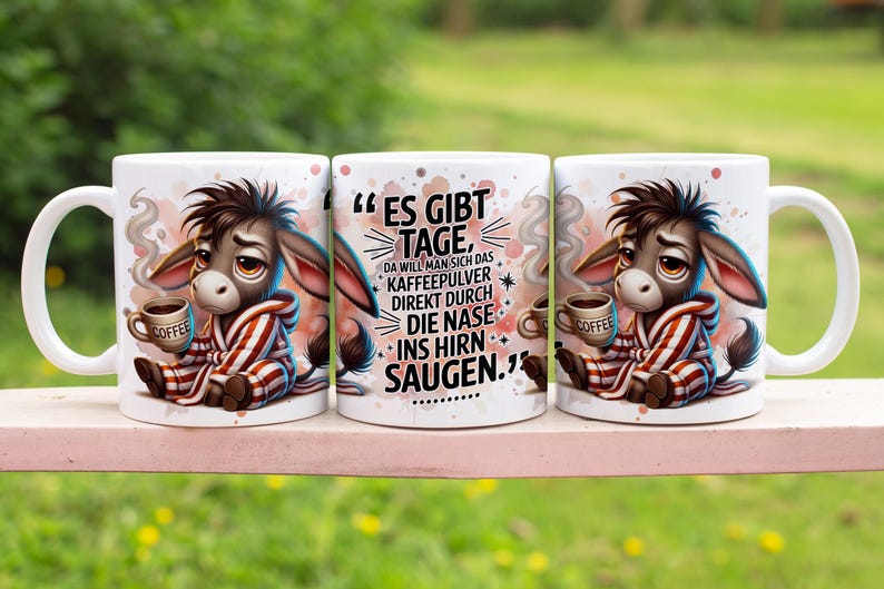 May include: Three white ceramic mugs with a cartoon donkey design. The mugs have a black handle and a black rim. The text on the mug reads "ES GIBT TAGE, DA WILL MAN SICH DAS KAFFEEPULVER DIREKT DURCH DIE NASE INS HIRN SAUGEN."