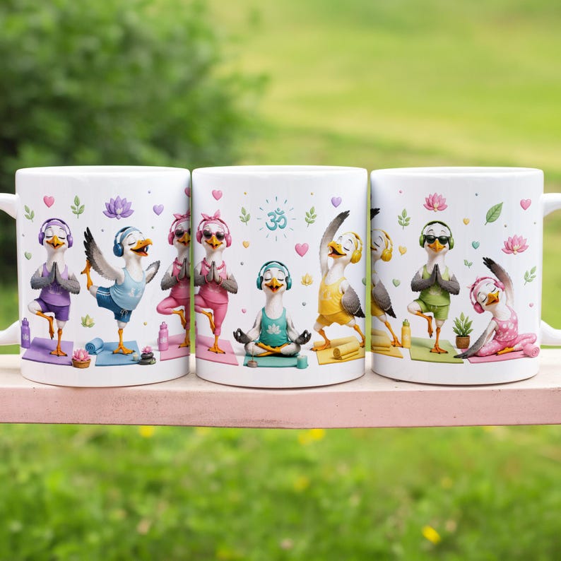 May include: Three white ceramic mugs featuring a repeating graphic print of cartoon seagulls in various yoga poses. The seagulls wear colorful athletic clothing and headphones, surrounded by small lotus flowers, hearts, and an Om symbol.