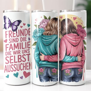 Puede incluir: Vaso blanco con texto en alemán: "FREUNDE SIND DIE FAMILIE DIE WIR UNS SELBST AUSSUCHEN." El diseño presenta a dos personas abrazándose, rodeadas de flores y corazones. Incluye una pajita. Forma cilíndrica.