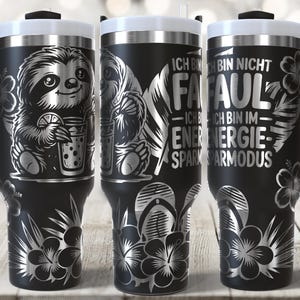 May include: Black travel mugs with white lids and black handles. The mugs feature a sloth design, floral patterns, and German text. One mug shows a sloth with a drink, while others have text that reads "I'm not lazy, I'm in energy-saving mode."