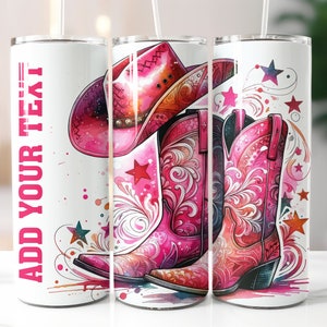 May include: White tumbler with a pink cowboy hat and boots design. The tumbler has the text "Add Your Text" on the side.