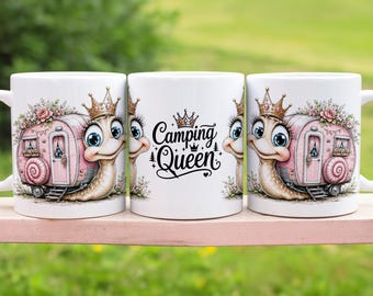 May include: A white ceramic mug featuring a cartoon snail with a pink camper shell on its back, wearing a gold crown. The design includes floral accents and the text Camping Queen in black script. The illustration is repeated on both sides of the mug.