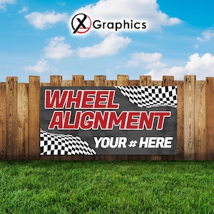 May include: A banner with the text "WHEEL ALIGNMENT" in red letters on a dark gray background, with the words "YOUR # HERE" in white. The banner has checkered flag designs and is set against a wooden fence and green grass.