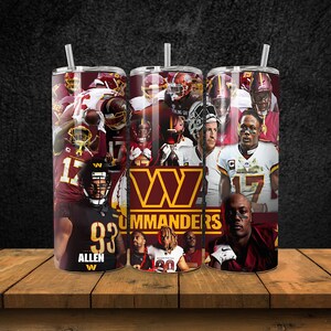 May include: A red and gold stainless steel tumbler with a collage of Washington Commanders football players. The tumbler features the team's logo and the word "Commanders".