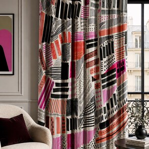 May include: A patterned curtain with a modern design. The curtain features a cream background with bold geometric shapes in black, pink, and orange. The design includes stripes, rectangles, and dotted patterns, creating a vibrant and artistic look.