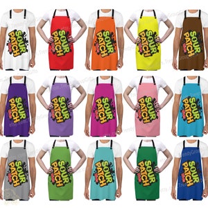 May include: A collection of twelve aprons in various solid colors, each featuring black neck and waist straps and a central graphic print that reads Sour Patch Kids in yellow and orange letters over a black splattered background design.