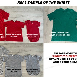 May include: A collection of red, green, and gray t-shirts and a baby bodysuit. The shirts are labeled with brand names and sizes, including "BELLA CANVAS 3001" and "RABBIT SKINS 3321". The text on the image says "REAL SAMPLE OF THE SHIRTS".