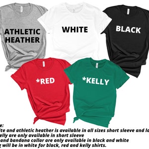 May include: A collection of short-sleeved t-shirts in various colors: athletic heather, white, black, red, and kelly green. Each shirt displays a bold, white text with the color name. The shirts are neatly arranged, showcasing the available color options.