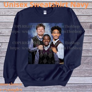 May include: Navy blue unisex sweatshirt featuring a group photo of three people. The image is centered on the sweatshirt. The text "Unisex Sweatshirt Navy" is at the top. Copyright information is visible on the image.