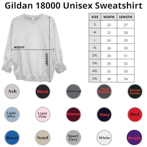 May include: A light gray Gildan 18000 unisex sweatshirt. The image includes a size chart with measurements in inches and a color palette featuring Ash, Black, Charcoal, Dark Heather, Forest Green, Light Blue, Light Pink, Maroon, Navy, Red, Royal, Sand, Sport Grey, White, and Purple.