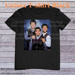May include: Black unisex t-shirt featuring a printed image of three men in argyle vests and collared shirts. The shirt has text at the top that says "Unisex T-shirt Black". The bottom of the shirt has text that says "the photos shown are just examples".