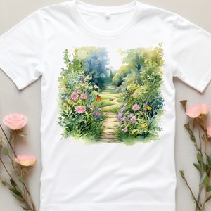 May include: White t-shirt with a watercolor print of a garden path lined with flowers and butterflies.