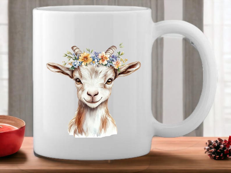 May include: White ceramic mug with a watercolor illustration of a goat wearing a flower crown. The goat has brown fur and a white face. The flowers in the crown are yellow, blue, and purple.