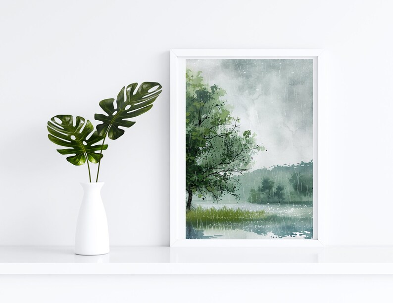 May include: A framed watercolor painting of a lake scene with a large tree in the foreground and a misty background. The painting is in shades of green, blue, and gray.