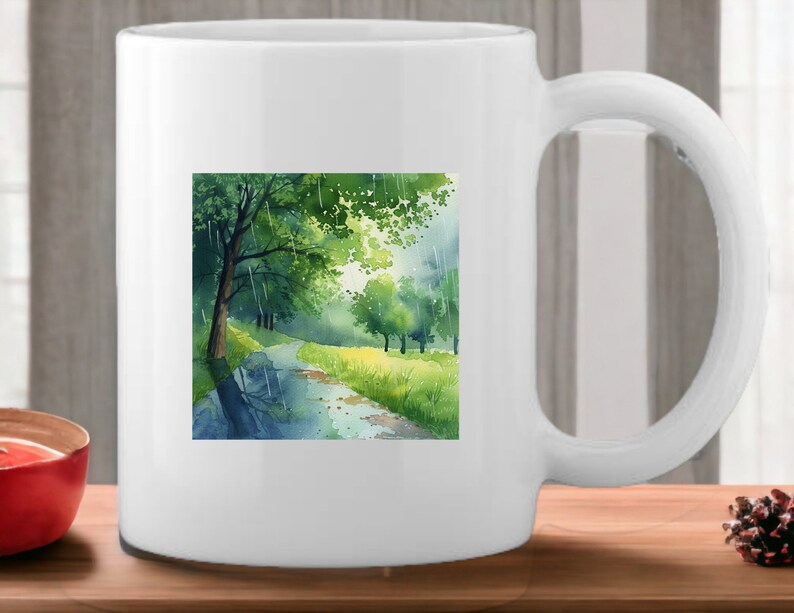 May include: White ceramic mug with a watercolor illustration of a green forest path with a stream running through it. The path is lined with trees and the stream is reflecting the sky.