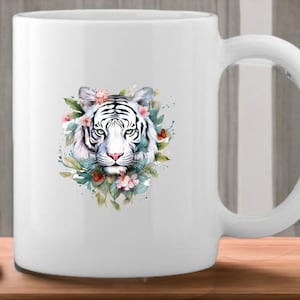May include: White ceramic mug with a watercolor illustration of a white tiger's face surrounded by flowers and leaves.