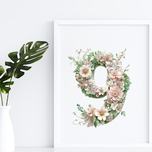 May include: A white frame with a floral design in the shape of the number nine. The flowers are pink and white with green leaves.