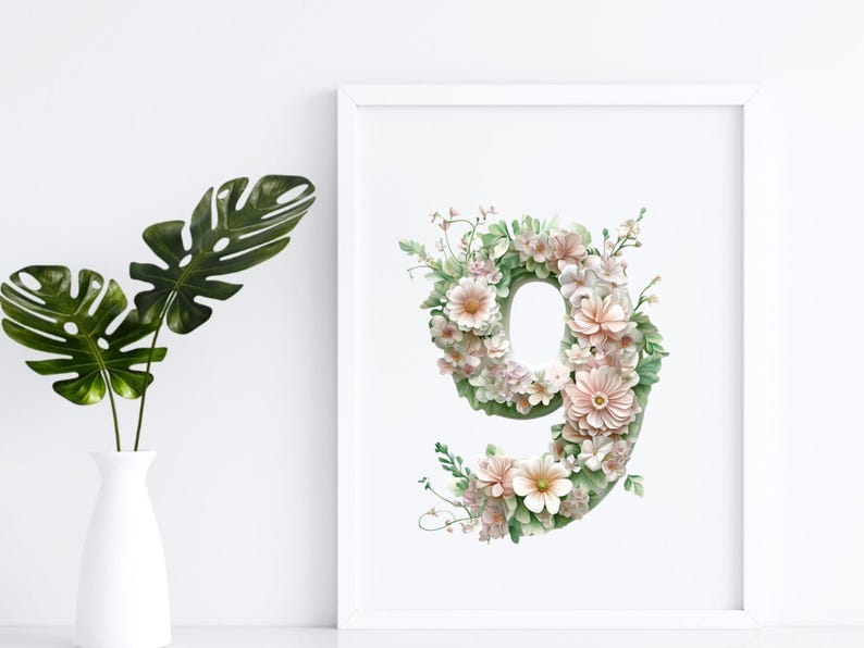 May include: A white frame with a floral design in the shape of the number nine. The flowers are pink and white with green leaves.