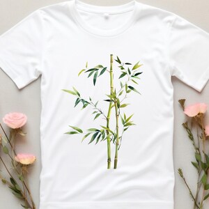 May include: White t-shirt featuring an illustration of a green bamboo plant.