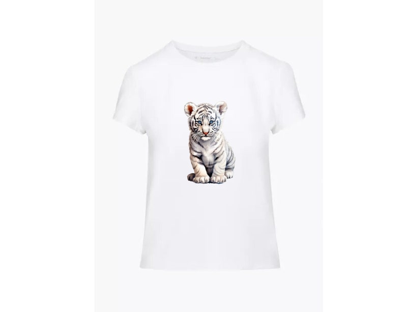 May include: White t-shirt with a graphic of a white tiger cub sitting down.
