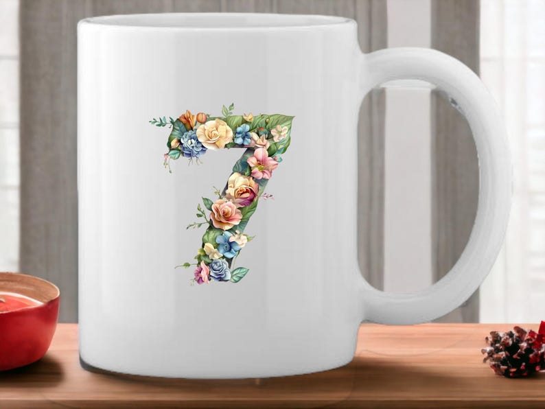 May include: White ceramic mug with a floral design in the shape of the number 7. The flowers are in shades of pink, yellow, blue, and green.