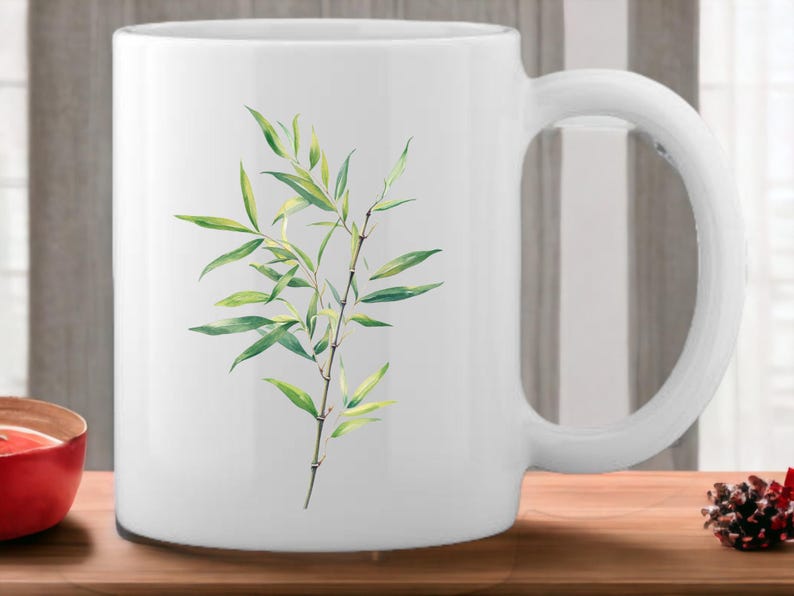 May include: White ceramic mug featuring a green bamboo plant design. The mug has a handle on the right side.