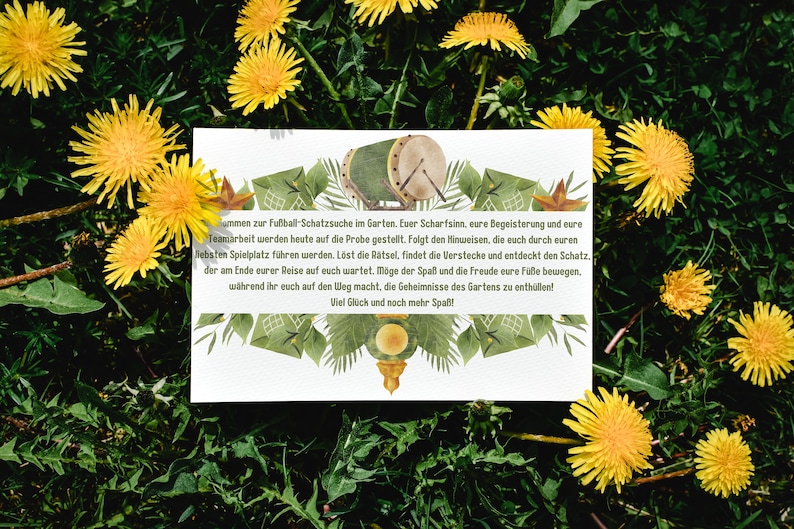 May include: A white card with text, a drum illustration, and green leaf accents, set against a backdrop of green grass and yellow dandelions. The card's text invites players to a garden treasure hunt.