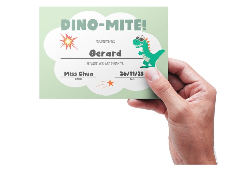 May include: A green dinosaur wearing sunglasses and a bandage is on a light green certificate with the text "DINO-MITE!" and "PRESENTED TO Gerard BECAUSE YOU ARE DYNAMITE!"  The certificate also includes the text "Miss Chua TEACHER" and "26/11/23 DATE".