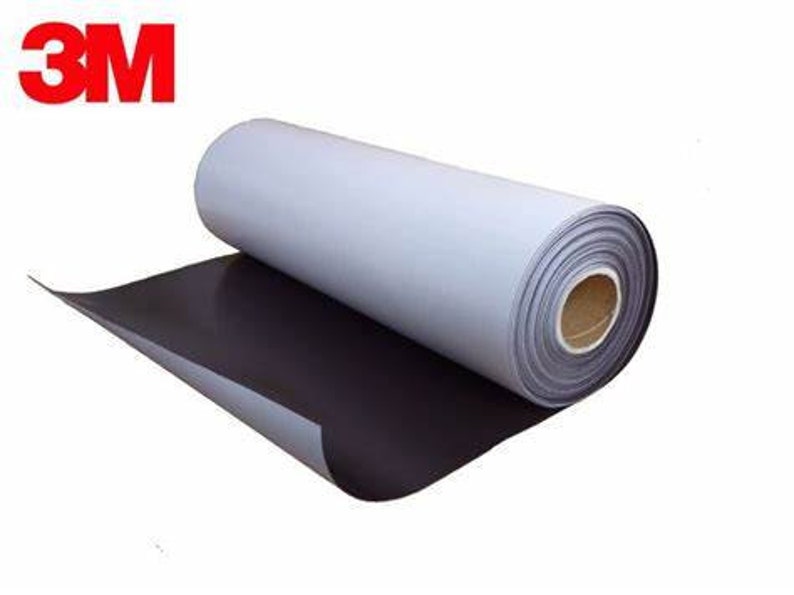 May include: A roll of magnetic sheeting with a white backing. The sheeting is rolled up and the white backing is visible. The sheeting is labelled with the 3M logo.