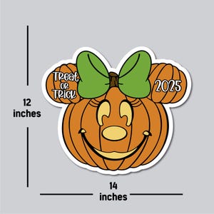 May include: A Halloween-themed pumpkin sticker with a smiling face, green bow, and mouse ears. The sticker is orange, with the words "Treat or Trick" and the year "2025" on the ears. It measures 12 inches high and 14 inches wide.