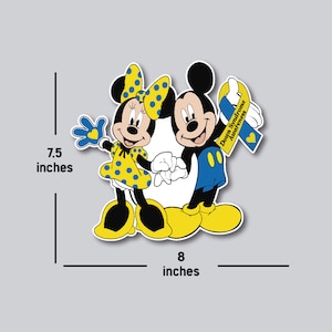May include: Mickey Mouse and Minnie Mouse holding hands with a blue and yellow ribbon that says "Down Syndrome Awareness". The characters are 7.5 inches tall and 8 inches wide.