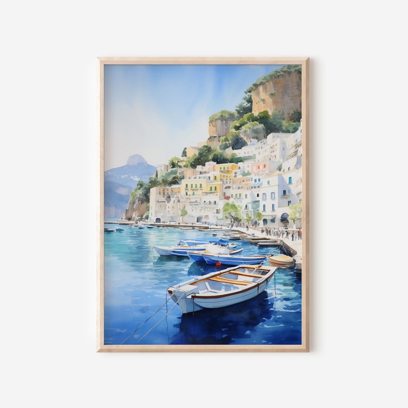 May include: Watercolor painting of a colorful Italian village on a cliffside overlooking a blue bay with several small boats docked. The sky is a bright blue with white clouds.