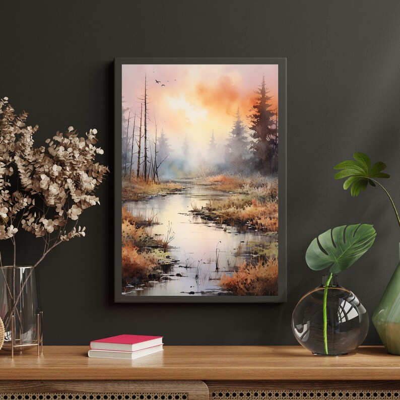 May include: A watercolor painting of a misty forest scene with a winding river in the foreground. The sky is a soft orange and pink, and the trees are silhouetted against the light.