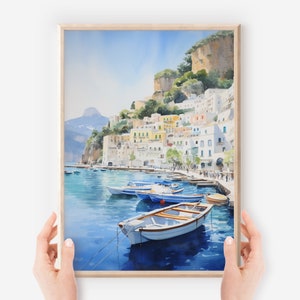 May include: Watercolor painting of a colorful Italian village on a cliffside overlooking a blue bay with several small boats in the water.