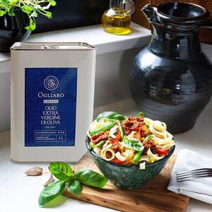 May include: A 3 liter can of Ogliaro Il Delicato Extra Virgin Olive Oil, Italian, with a blue label and a gold logo. The can is sitting on a wooden cutting board next to a bowl of pasta with green beans, red peppers, and basil.