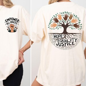 a woman wearing a white shirt with a tree on it