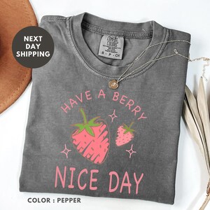 a t - shirt that says have a berry nice day with strawberries on it