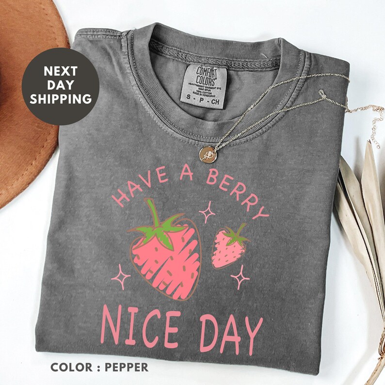 a t - shirt that says have a berry nice day with strawberries on it