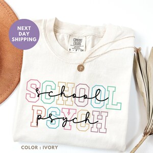 a t - shirt that says school project next to a hat