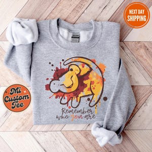 a gray sweatshirt with a cartoon giraffe on it