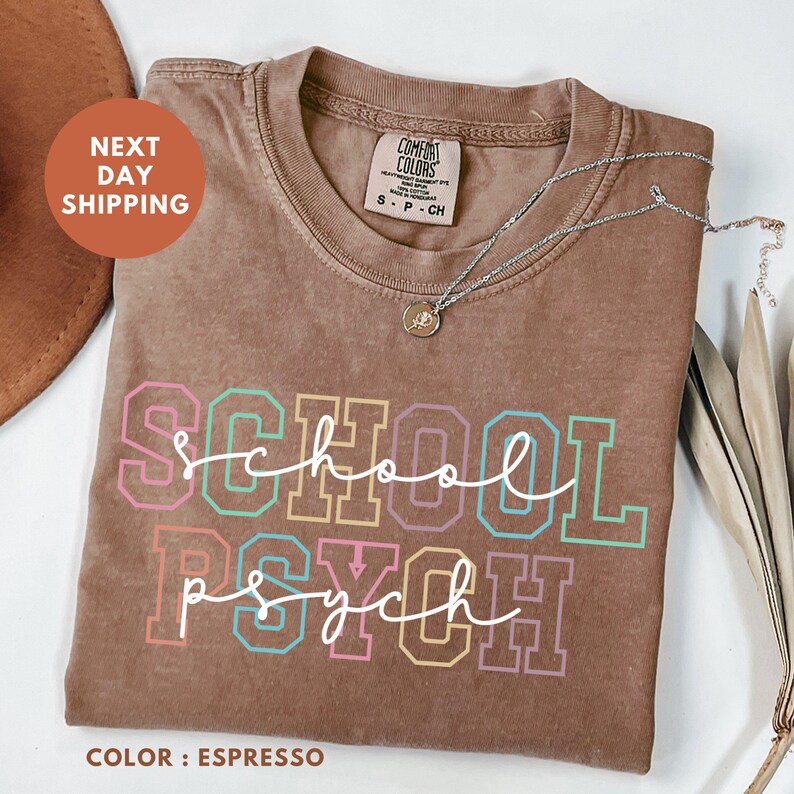 a t - shirt that says school psychh next to a pair of scissors