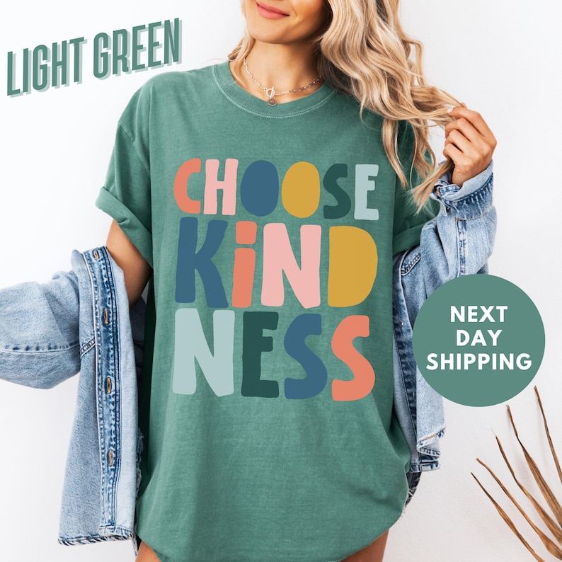 a woman wearing a t - shirt that says choose kind of nesss next to