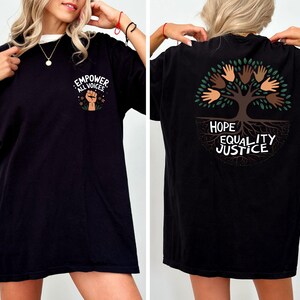 a woman wearing a black shirt with a tree on it