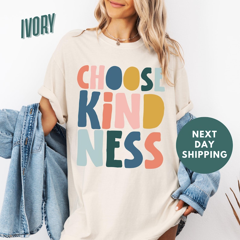 a woman wearing a t - shirt that says choose kind of nesss next to