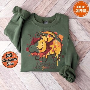 a green sweatshirt with a lion on it