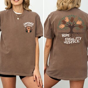 a woman wearing a brown shirt with a tree on it