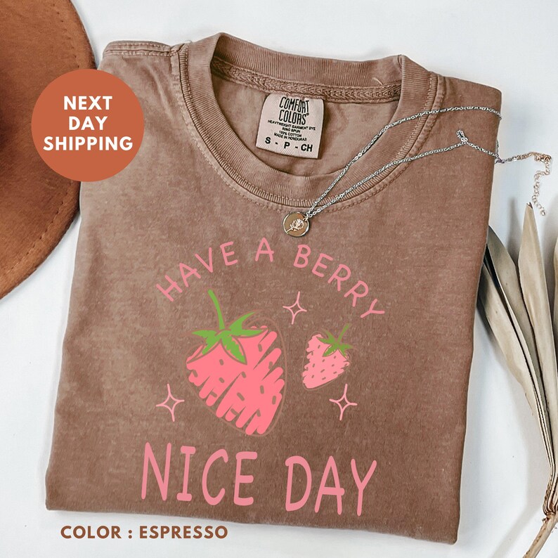 a brown t - shirt with a strawberry on it
