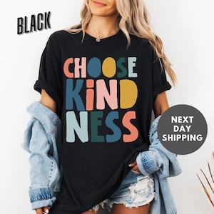 a woman wearing a black t - shirt that says choose kind of nesss next